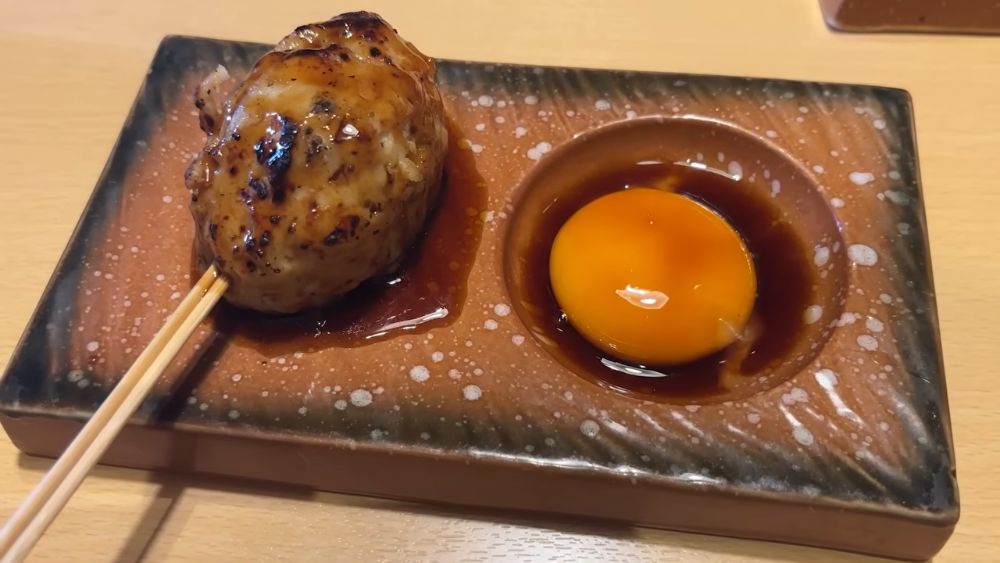 Chicken tsukune skewer with raw egg yolk dip at Inanowa Yurakucho, Tokyo